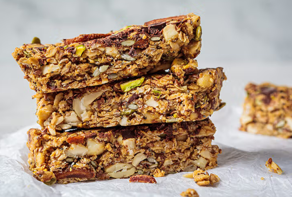 Open protein bar showing layers of nuts and chocolate – high quality protein bars for muscle gain in Pakistan – Hamza The Dietitian